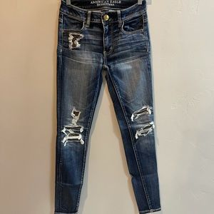 American Eagle super stretch dark wash skinny jeans with patched distressing